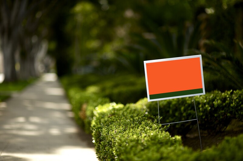 a red board placed in a garden